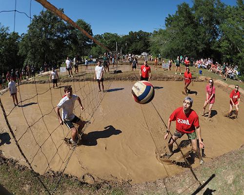 Student playing oozeball in the mud.